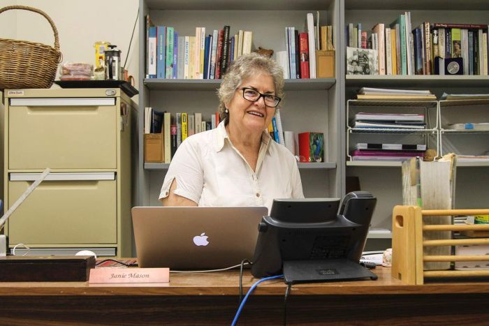 a woman sitting at a desk