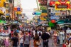 People walking along the busy streets of Khao San Road in Bangkok, Thailand.