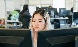 A female engineer looking at monitors.