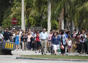 People evacuated because of a bomb threat return to the David Posnack Jewish Community Center and David Posnack Jewish Day School, Monday, Feb. 27, 2017, in Davie, Fla.