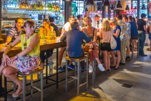 Tourists and locals enjoying drinks and tapas at the Mercado de San Miguel in  Madrid