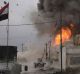 A car bomb explodes next to Iraqi Special Forces armored vehicles as they advance towards Islamic State held territory ...
