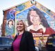 Sinn Fein leader Michelle O'Neill stands in front a mural of republican hunger striker Bobby Sands after holding a post ...