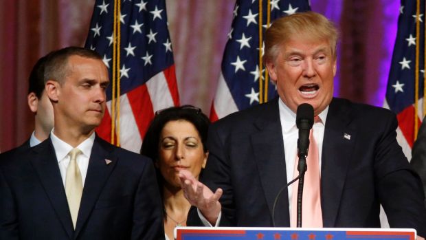 On the campaign trail: Corey Lewandowski listens at left as Trump speaks. He was fired in June.