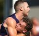 Dockers Ed Langdon and Hayden Crozier (centre) celebrate Langdon's match-winning goal after the siren.
