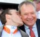 Tony McEvoy is kissed by Luke Currie after their Australian Guineas success.