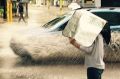 A sunshade had to be re-appropriated to a rain cover after unusual summer deluge hit Perth.