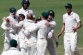 Boilover: The Australians celebrate winning the first Test against India in Pune.