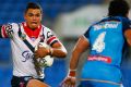 On the burst: Latrell Mitchell takes on the Titans defence.