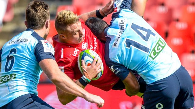 Ruan Ackermann of the Lions is upended by Waratahs Jack Dempsey and Reece Robinson in Johannesburg on Saturday.