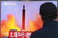 A man in Seoul watches a TV news program on North Korea's missile launches.