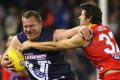 Damian Monkhorst of Victoria fends off a tackle by Andrew Embley during the 2015 EJ Whitten Legends Game.