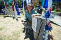 Dave 'Spurs' Goodall with his dog RM of Cook decorates his home for an Australia Day neighbourhood party celebration. 