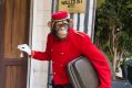 Doorman stands at the entrance of the "The Walled Off Hotel".