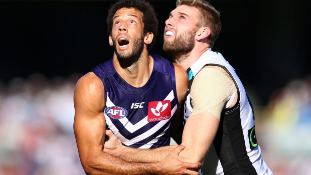 PERTH, AUSTRALIA - JUNE 18: Zac Clarke of the Dockers and Jackson Trengove of the Power contest the ruck during the ...