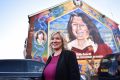 Sinn Fein leader Michelle O'Neill stands in front a mural of republican hunger striker Bobby Sands after holding a post ...