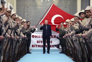 Young supporters in old military uniforms greet Turkey's President Recep Tayyip Erdogan as he arrives to address a meeting in Istanbul, Sunday, March 5, 2017.