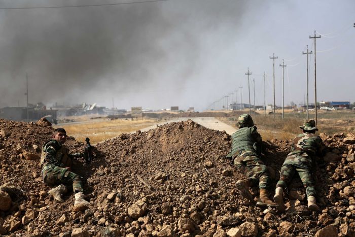 Kurdish security forces take up a position