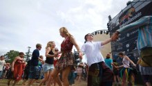 Revellers at the Womadelaide festival dance in front of a stage