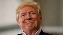 US President Donald Trump smiles a as he holds a "Make America Great Again" rally