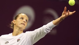 Karolina Pliskova of the Czech Republic serves the ball to Denmark's Caroline Wozniacki