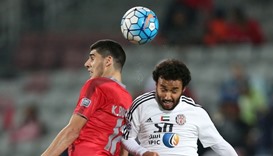 UAE Al-Jazira's Mohamed Jamal (R) fights for the ball with Qatar Lekhwiya's karim Boudiaf