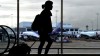 Silhouette of woman walking through Sydney Airport