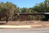 an empty house with brown lawn