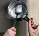 An activist beats with a spoon on saucepan during an anti corruption rally in Paris on Sunday.