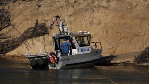 Police divers search the Murray River for the five-year-old