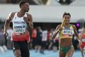 Briton Theo Campbell blowing Australia's Morgan Mitchell a kiss as he passes her to win the mixed 4x400 metre relay at Nitro.