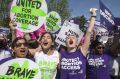 Abortion rights activists rejoice in front of the Supreme Court in Washington, Monday, June 27, 2016, as the justices ...