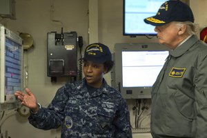 File - President Donald J. Trump is briefed by a sailor during a tour of the future USS Gerald R. Ford in Newport News, Va., Mar. 2, 2017.