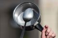 An activist beats with a spoon on saucepan during an anti corruption rally in Paris on Sunday.