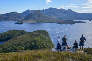 Guide Peter Marmion (L) with tourists from the Odalisque on top of Balmoral Hill, Port Davey.