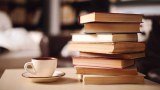 A pile of books and a cup and saucer