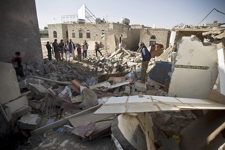 Yemenis in the rubble of homes destroyed by coalition airstrikes in the capital city of Sana'a CREDIT: Hani Mohammed / AP