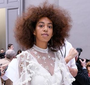 Solange Knowles looks angelic wearing a pretty white dress with sheer details and ruffles at the Chloé runway ...