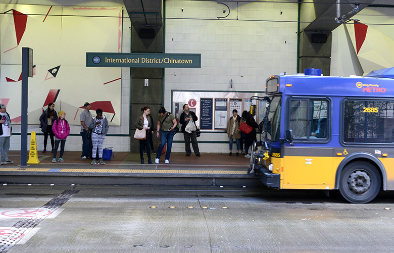 Transit riders wait for a Metro bus on Saturday, March 5, 2016, in Seattle’s International District transit tunnel station. According to U.S. Census data, 50% of International District residents commute by bus, the highest percentage of any neighborhood in King County.