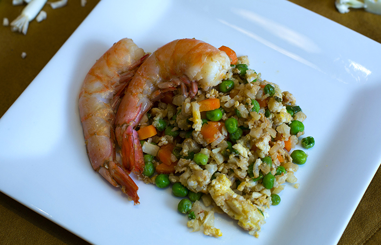 Cauliflower, transformed by the Paleo diet. This is the “fried rice” version, with shrimp, vegetables and green onions.