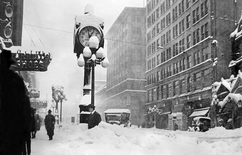 Big clock in big snowfall of 1912. Caption to come from Paul Dorpat.