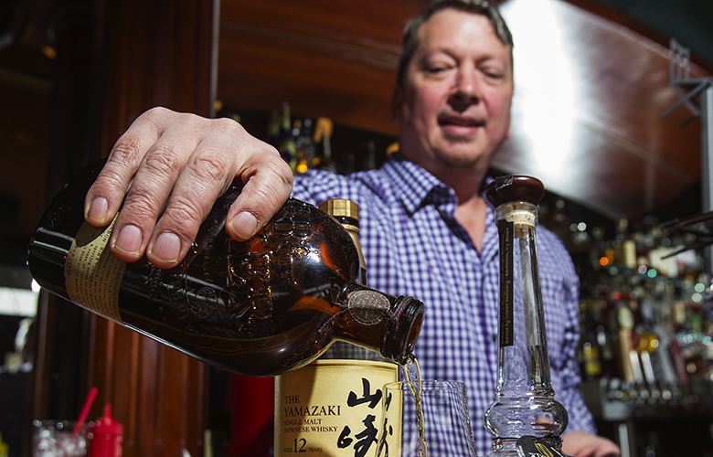 Mark Edmison, the general manager of the Deluxe Bar and Grill on Capitol Hill, pours a glass of whiskey by Bib and Tucker  Photographed at the Deluxe Bar and Grill on Capitol Hill Friday, April 10, 2015.