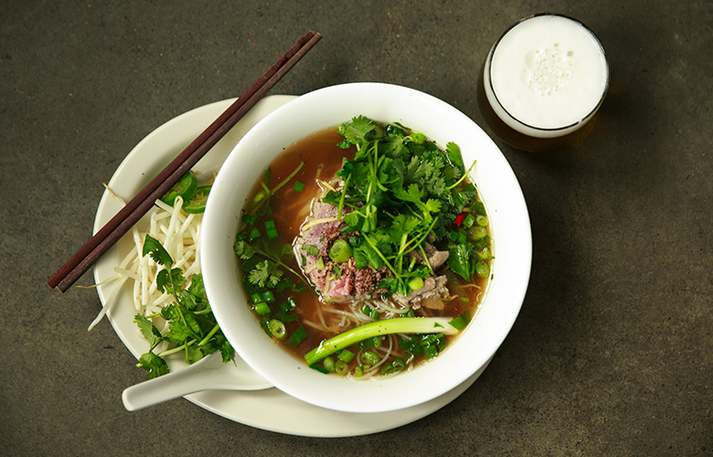 Ba Bar features Pho Ha Noi Style with rare beef, fresh ginger, pickled bird eye chilies, cilantro, green onion and a savory Chinese donut on the side.