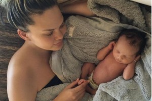 Chrissy Teigen with daughter Luna as a newborn.