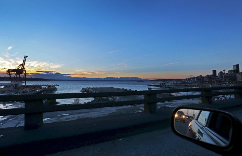 A drive along the upper deck of the Viaduct offers Seattle drivers a beautiful sunset view. “When you’re on it, you get to see the majesty of what we’ve built as well as the natural setting we live in,” says MOHAI executive director Leonard Garfield. (Ken Lambert/The Seattle Times)