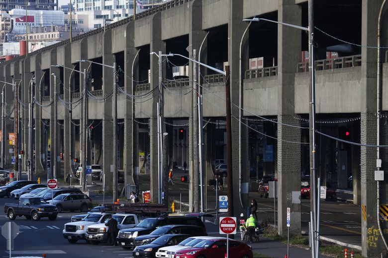 Looking north along the Alaskan Way Viaduct, the 1950s-era structure rises like a wall between city and sea. Not even the Viaduct’s designers considered it beautiful, but it served its purpose. (Ken Lambert/The Seattle Times)