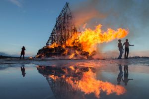 People react as a sculpture is burning at the Maslenitsa festival at the Nikola-Lenivets art park in Nikola-Lenivets ...