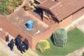 Heavily armed police outside the Dandenong North property on Tuesday.