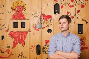 Art Gallery of NSW curator Nicholas Chambers with one of Andy Warhol's shop window designs for perfume. 