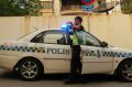 Police officers guard outside the North Korean Embassy in Kuala Lumpur.